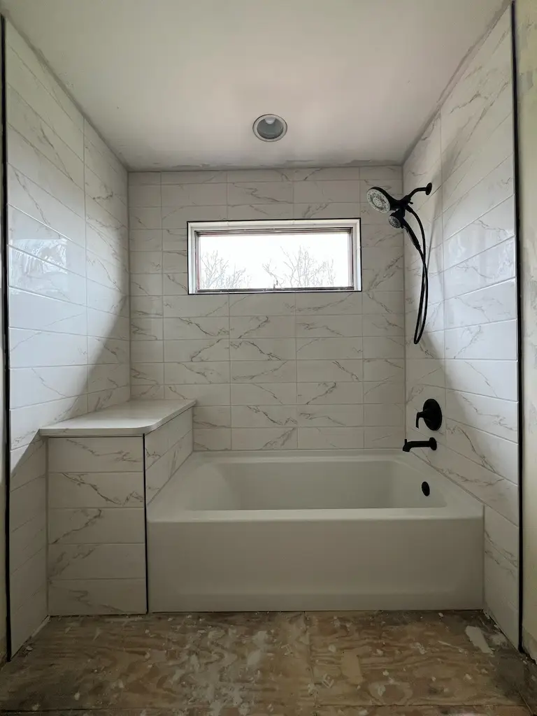 Modern tiled bathroom with bathtub progress
