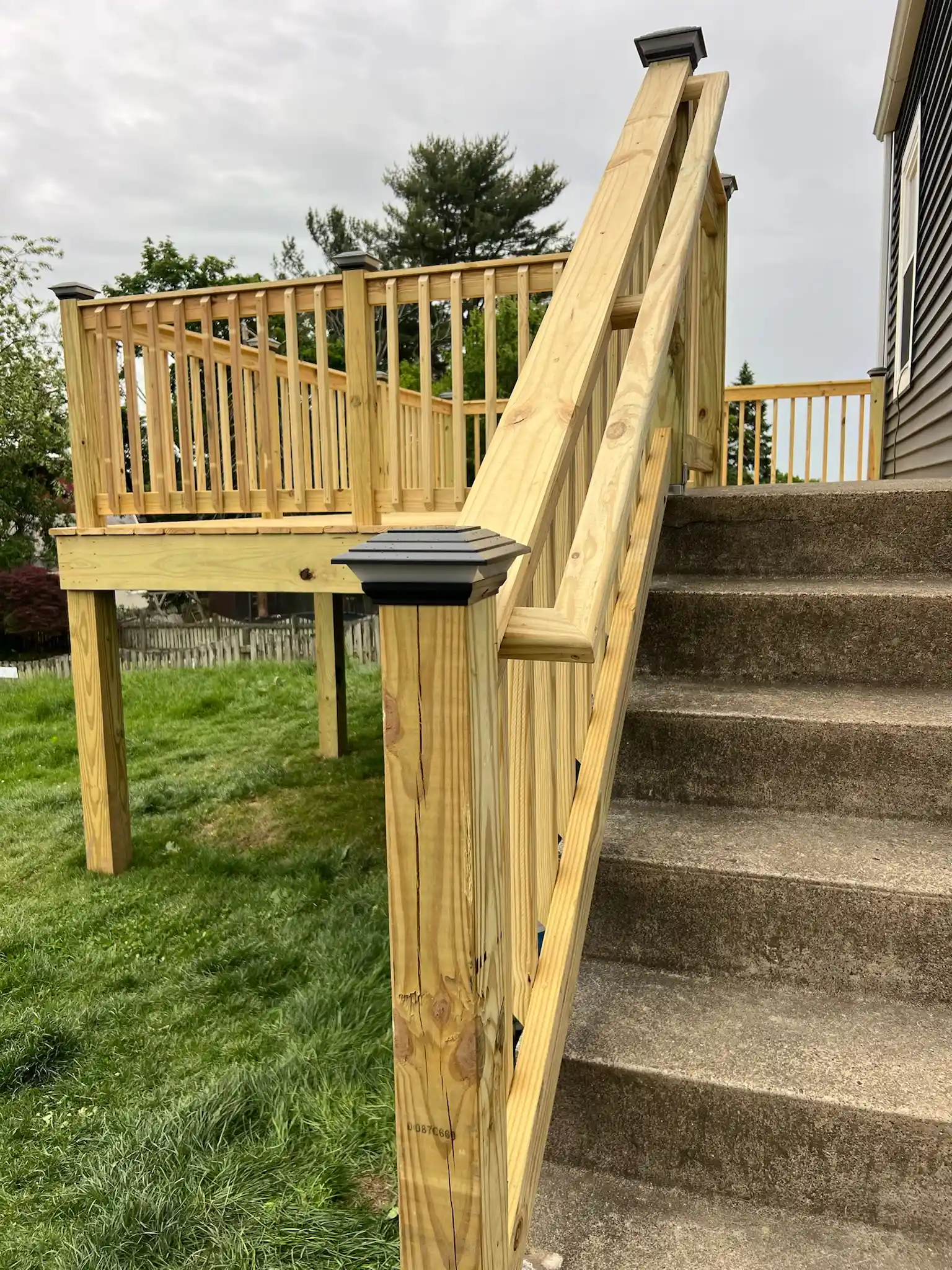Wooden deck addition on a backyard home progress