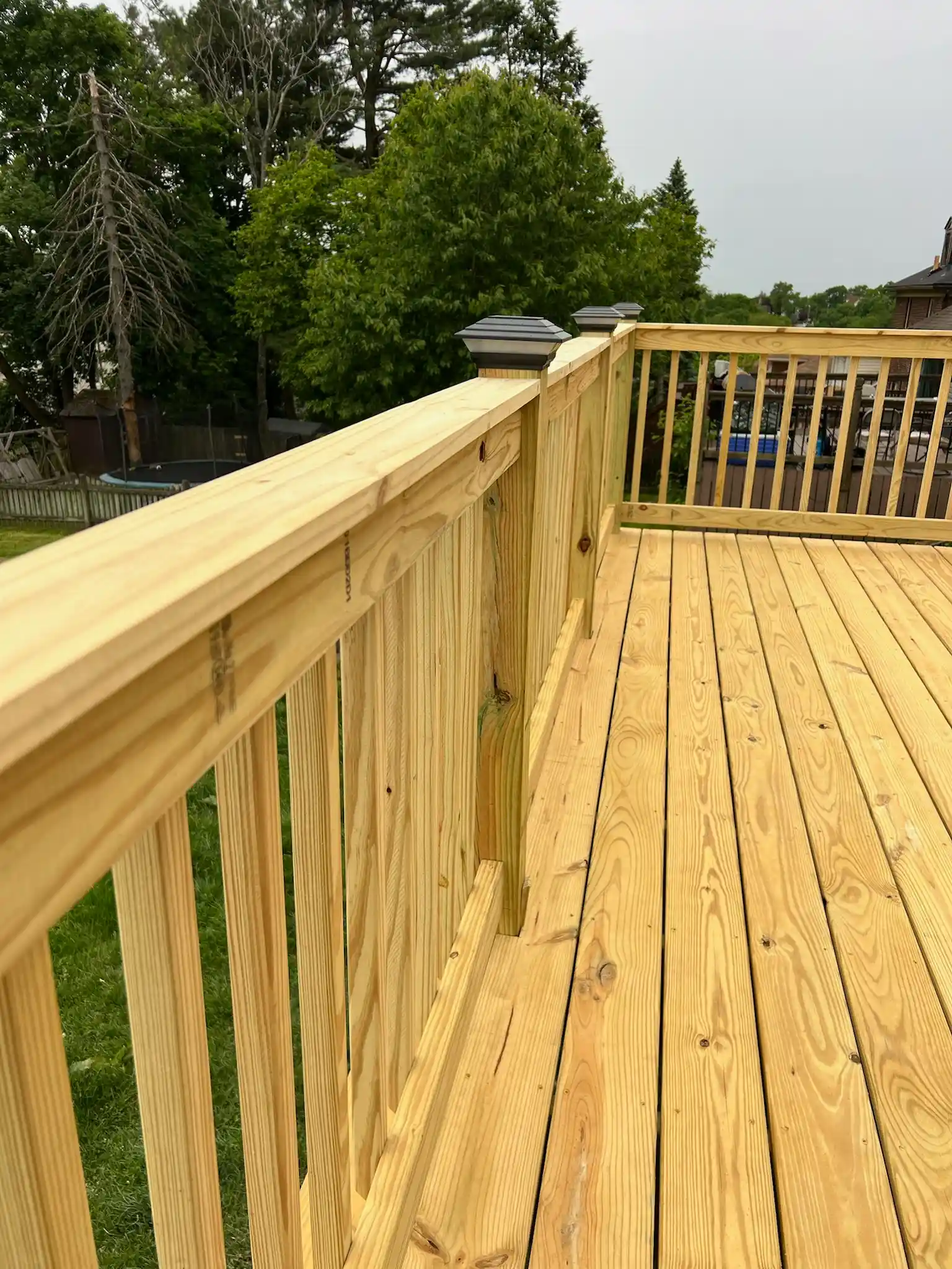 Wooden deck addition on a backyard home progress