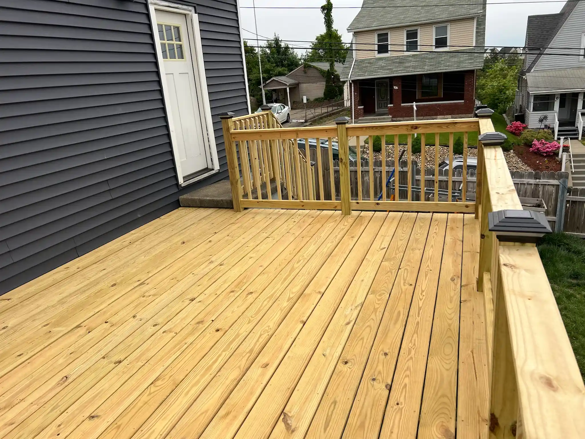 Wooden deck addition on a backyard home progress