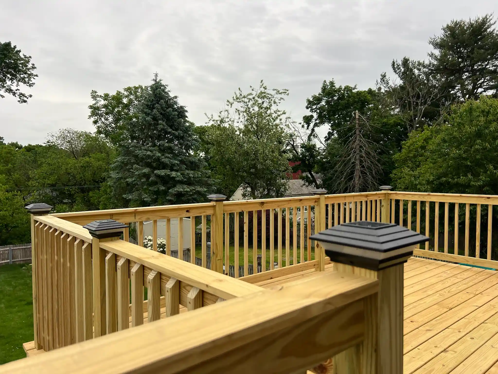 Wooden deck addition on a backyard home progress