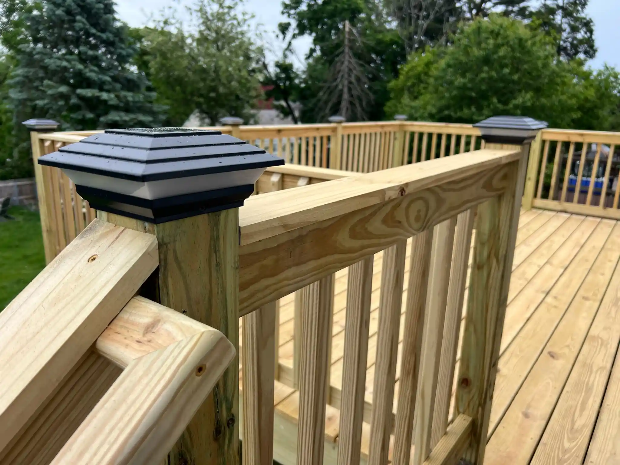 Wooden deck addition on a backyard home progress