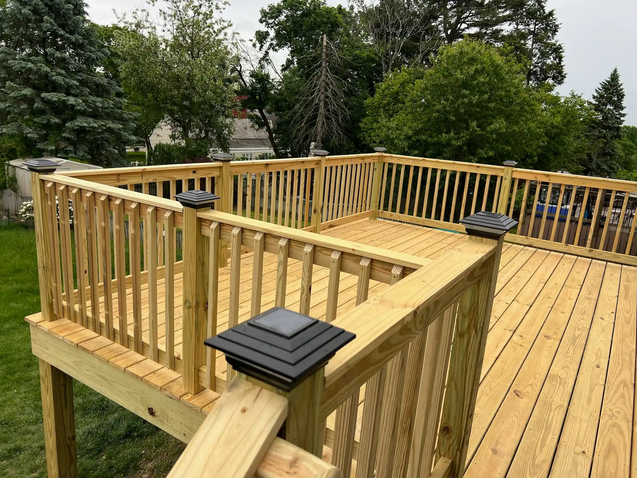 Wooden deck addition on a backyard home progress