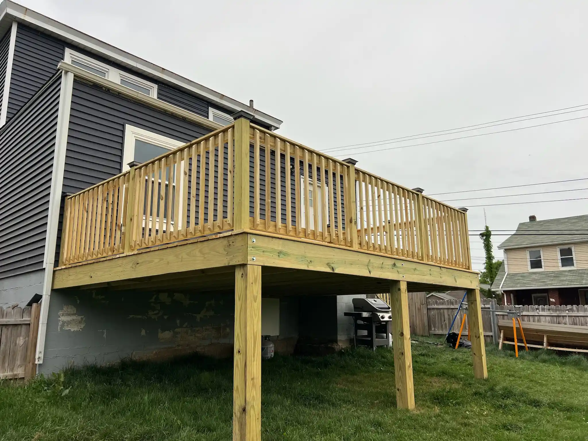 Wooden deck addition on a backyard home progress