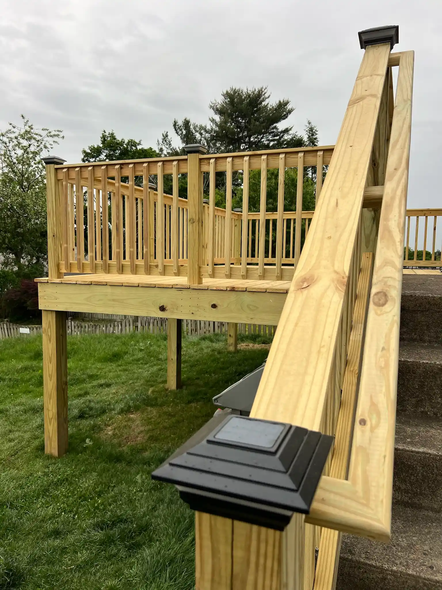 Wooden deck addition on a backyard home progress