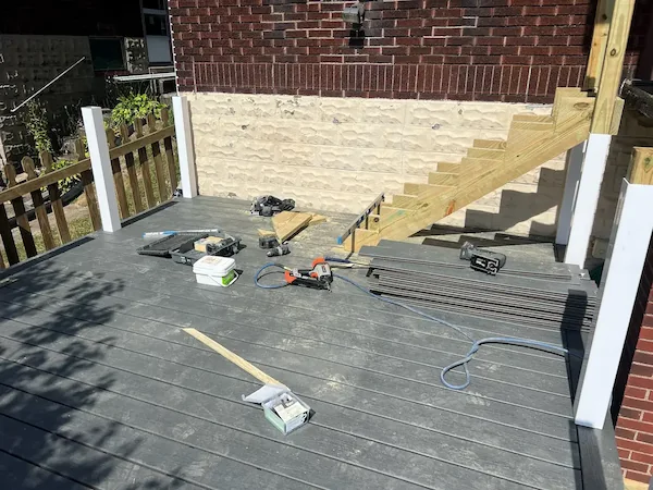 Wooden deck addition on a backyard home progress