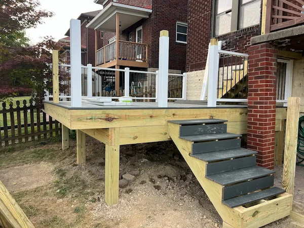 Wooden deck addition on a backyard home progress