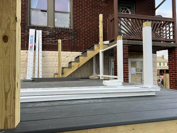 Wooden deck addition on a backyard home progress